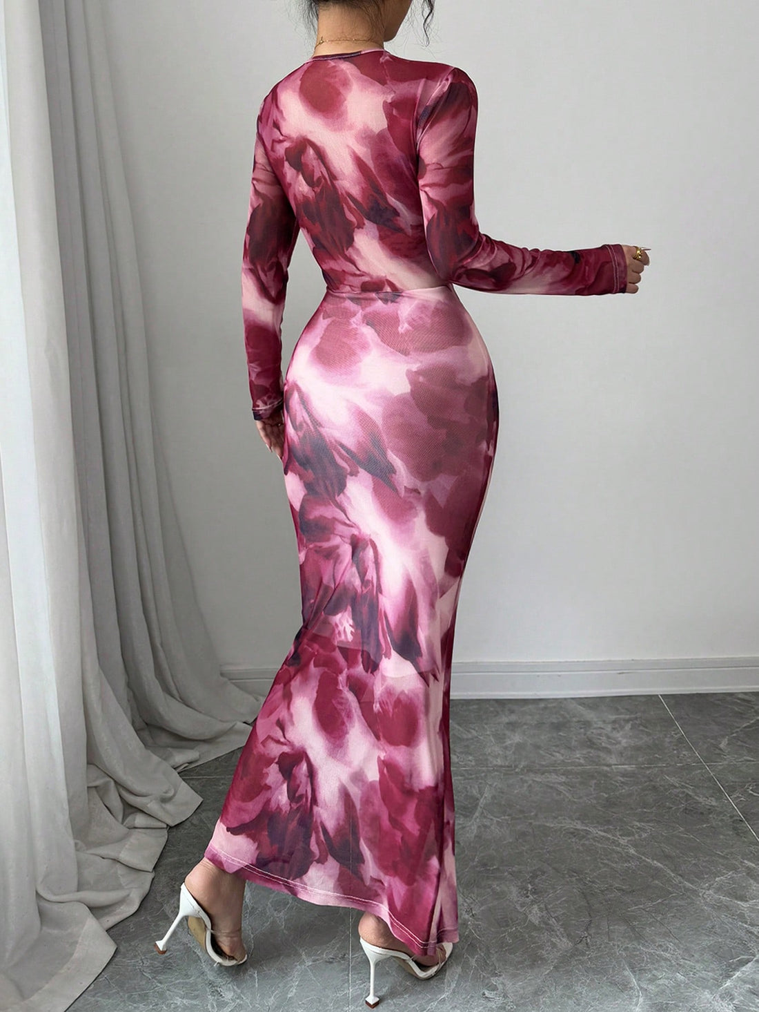 Be the trendsetter in this playful and flowing long sleeve mesh dress. With its asymmetrical hem and trendy tie-dye print, this dress is sure to turn heads. Express your unique style while staying comfortable in this fun and fashionable piece.