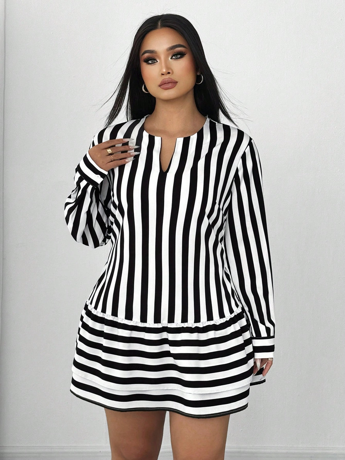 Embrace your curves this season with our charming striped mini dress, designed for those who love bold style with a touch of whimsy. The hollow-out lantern sleeves add an unexpected flair that catches eyes, while the playful ruffle hem keeps things fun and flirty. Perfect for casual outings, weekend adventures, or whenever you want to feel effortlessly put-together. The relaxed fit celebrates your shape without compromise, making this dress your new go-to for laid-back fall vibes that feel anything but ordi