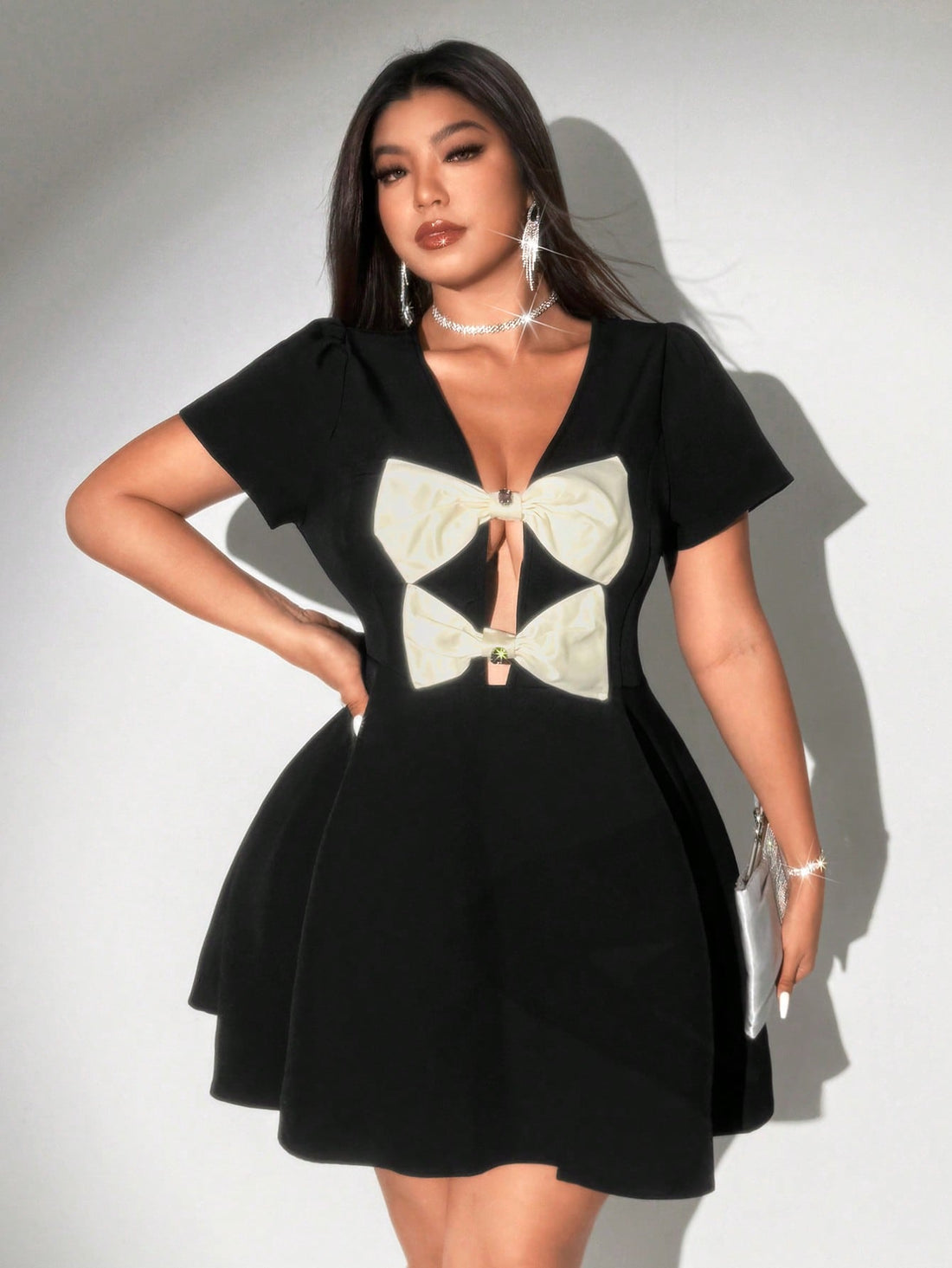 Step out in style with this playful plus size A-line mini dress, featuring a flattering deep V-neck and a charming bow detail. Its flirty silhouette enhances your curves while keeping comfort in mind, perfect for turning heads at any occasion. Embrace elegance with a fun twist!