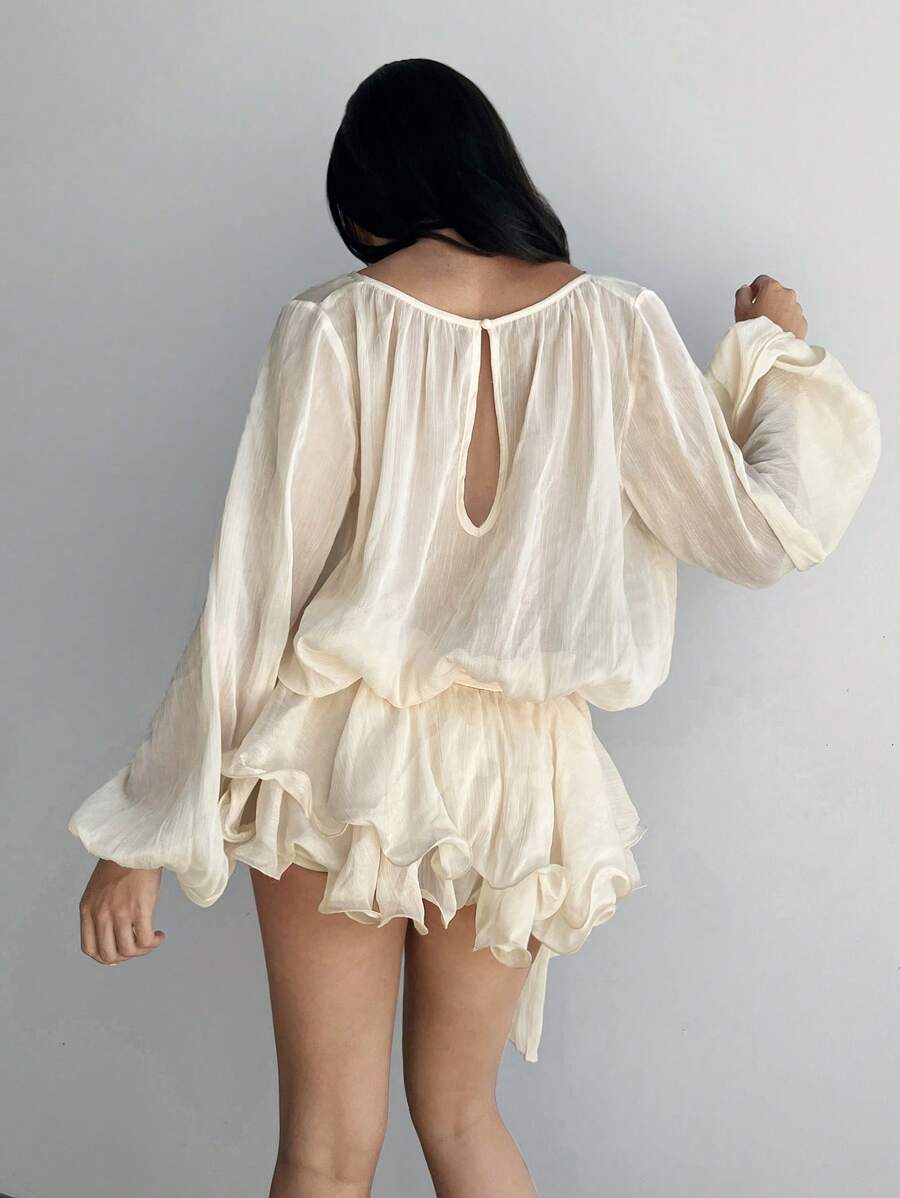 Step into a world of sparkle and charm with this glittering mini dress. Featuring whimsical lantern sleeves and a flirty ruffled hem, it’s designed to make every evening feel like a fairy tale. Perfect for twirling under the stars and turning heads wherever you go.