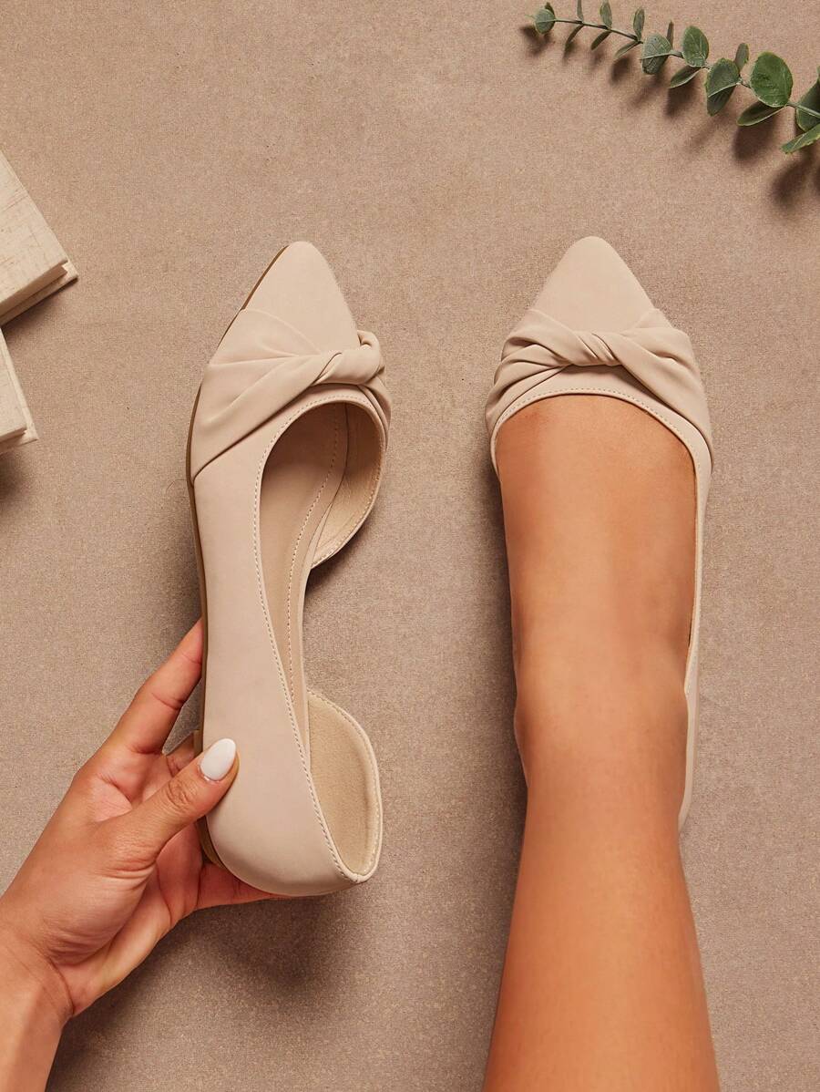 Pointed toe knot flats close up showing smooth faux leather finish
