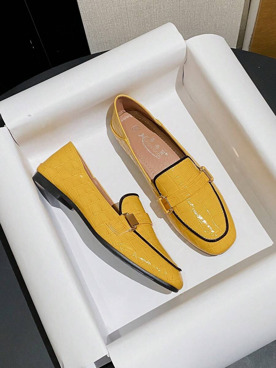 Mustard yellow crocodile embossed loafer worn with jeans