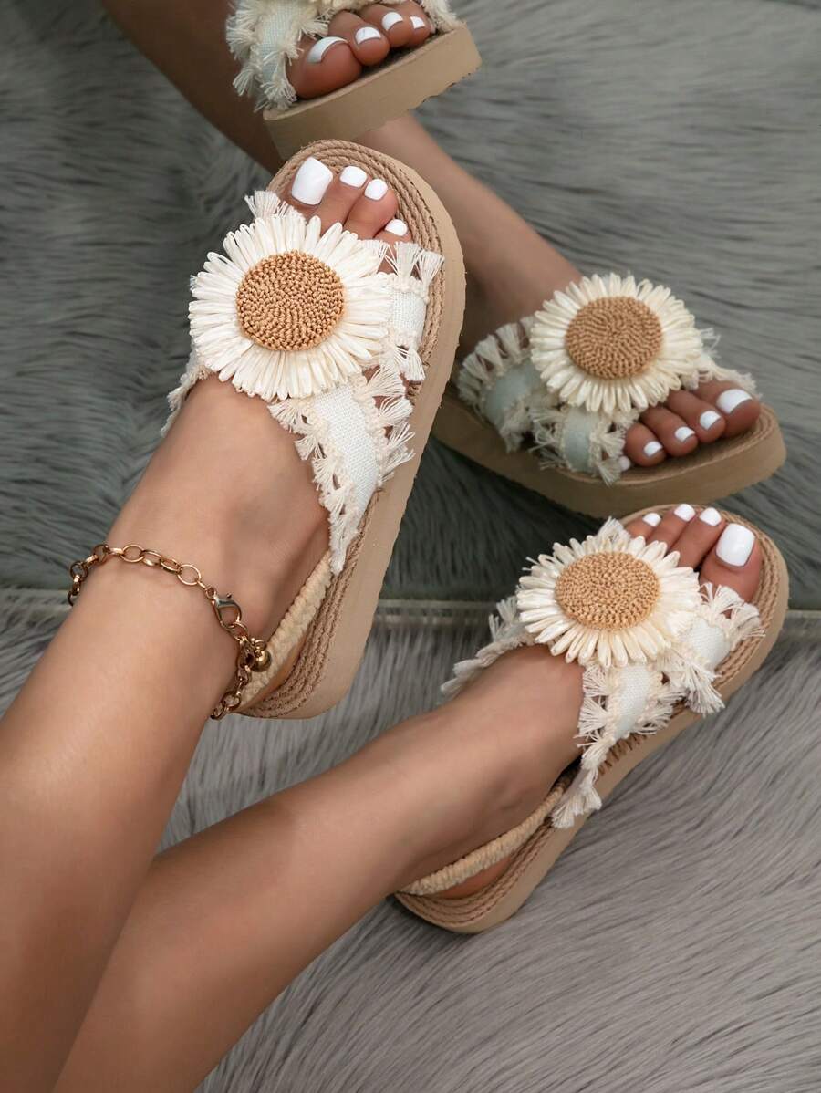 Overhead on-foot view of cream daisy sandals with fringed criss-cross straps