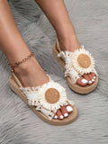 Front on-foot view of floral wedge sandals with open toes and camel trim