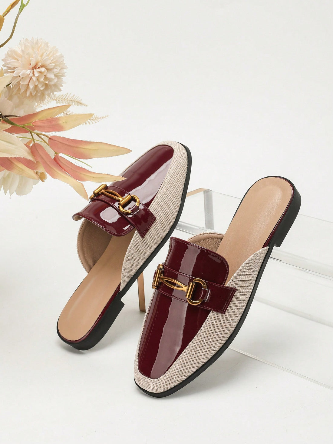 Step into effortless style with these burgundy flat mules that blend sophistication with comfort. The striking square toe silhouette pairs beautifully with a charming beige linen inlay, creating a look that's both modern and timeless. Whether you're heading to the office or out for a casual weekend adventure, these versatile mules transition seamlessly from season to season. The flat sole keeps you grounded and comfy all day long, while the rich burgundy hue adds that perfect pop of color to your fall and w