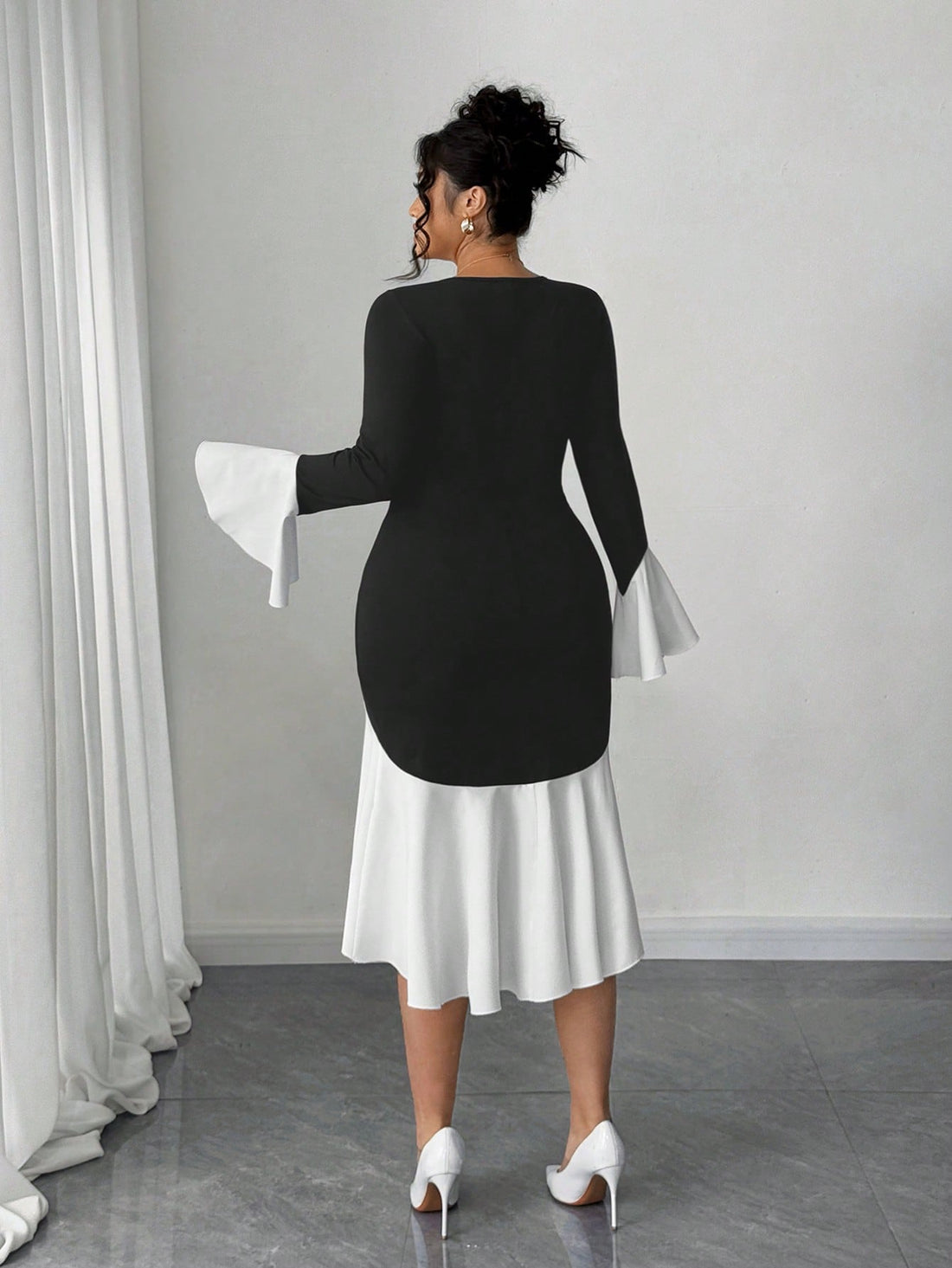 Elevate your fall wardrobe with this stunning plus-size dress that's equal parts bold and beautiful. The striking contrast color blocking catches every eye, while the flattering square neckline frames your face perfectly. Bell sleeves add a touch of whimsy and movement, creating an effortlessly chic silhouette that works for brunch, date night, or anywhere you want to feel fabulous. Designed for real bodies and real style, this dress proves that fashion should always be fun and flattering.