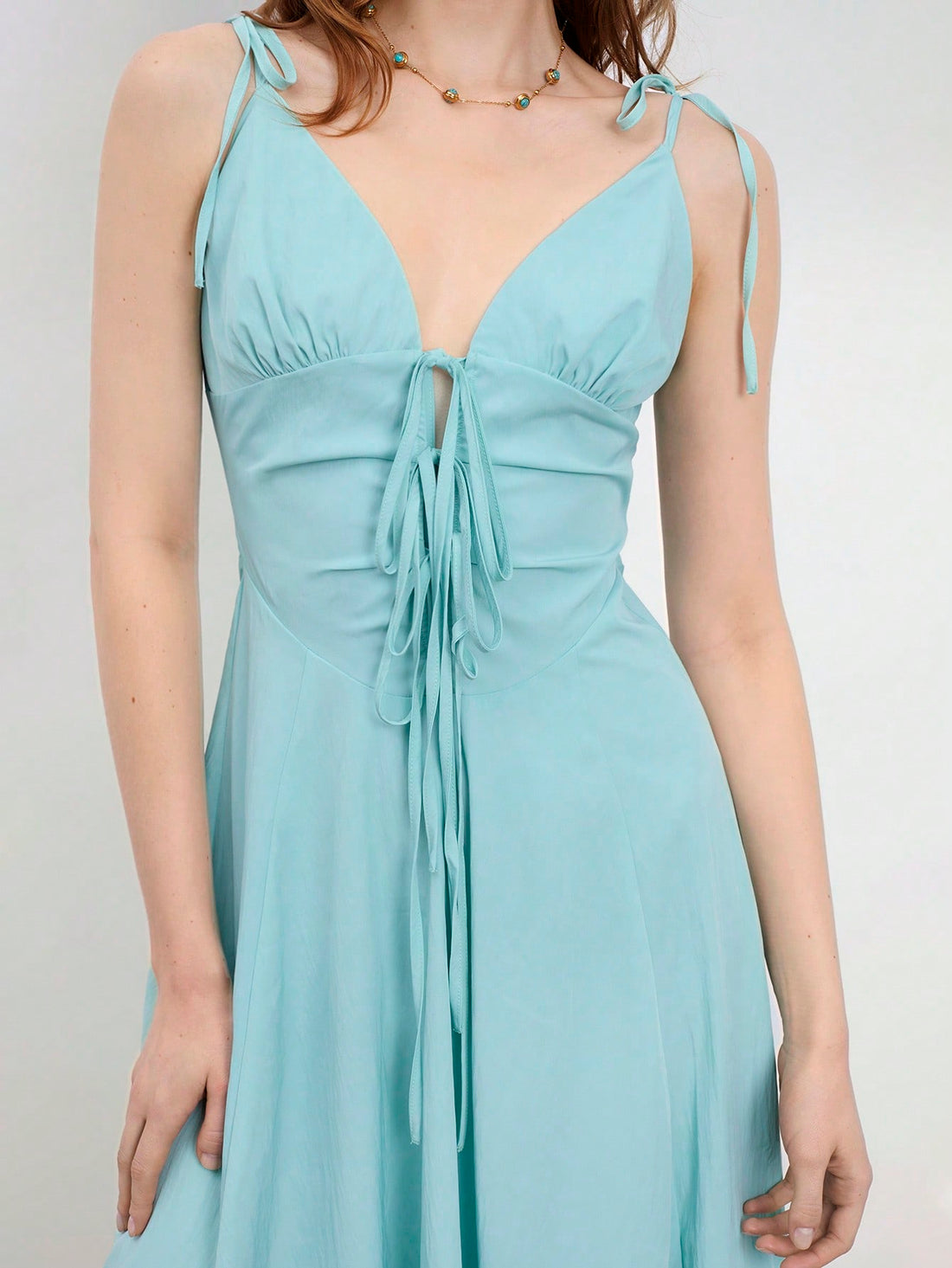 Elevate your warm-weather wardrobe with this charming mint green midi dress that's equal parts sophisticated and fun. The flattering V-neckline and delicate spaghetti straps create an effortlessly elegant silhouette, while the adorable bowknot detail adds a playful touch that'll have you feeling fabulous. Perfect for spring brunches, summer garden parties, or any occasion calling for a little extra polish. Slip it on and let the compliments flow!