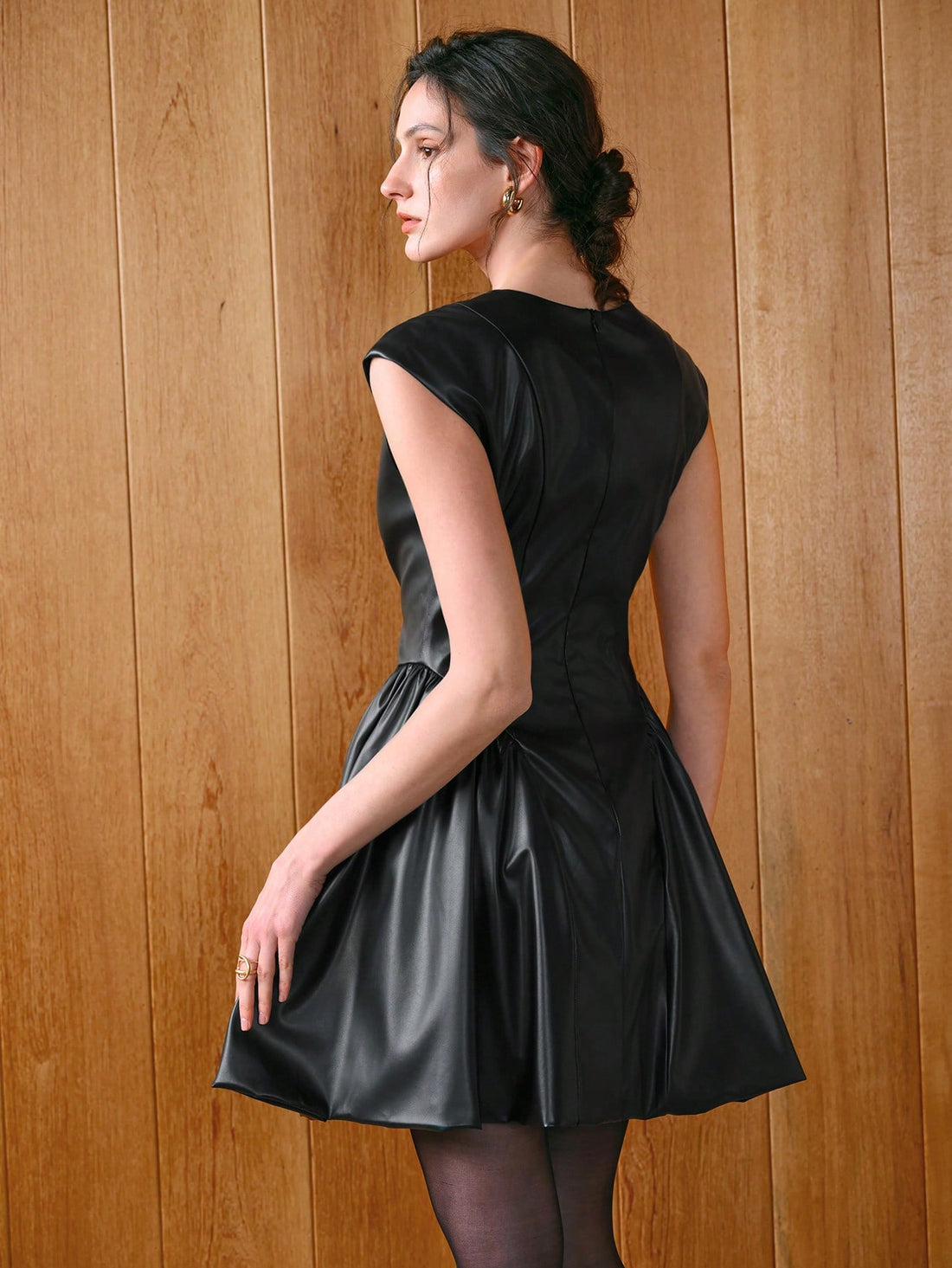 Unleash your inner fashionista with our Chic V-Neck PU Leather Peplum Sleeve Mini Dress! This trendy dress combines edgy faux leather with playful peplum sleeves for a unique and stylish look. Perfect for any occasion, this dress will make you stand out in a sea of boring fashion. (No boring looks here!)