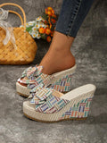 Open toe summer slide sandal with oversized bow and multicolor geometric weave.