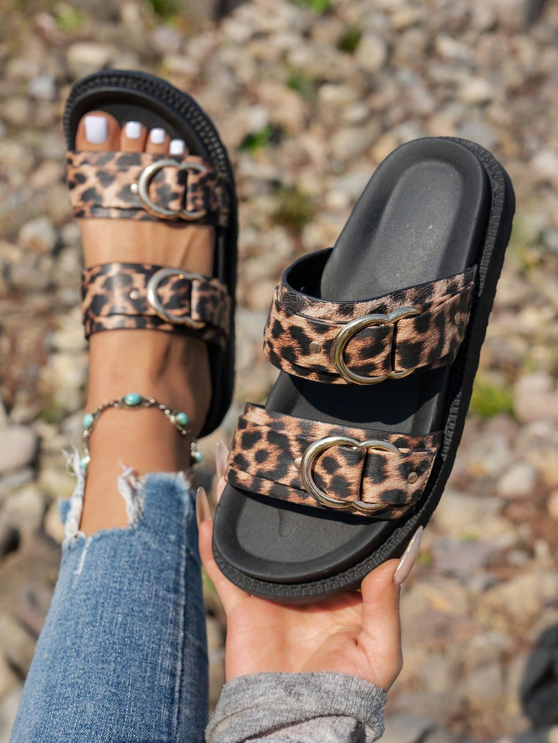 Step out in style with these playful leopard print flat sandals! Featuring a thick sole for comfort and a shiny gold buckle for a touch of glam, they’re perfect whether you’re lounging indoors or exploring outdoors. Easy to slip on and made to turn heads, these sandals add a fun, fierce edge to any outfit.