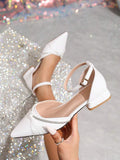White pointed-toe PU leather flat with satin bow, rhinestone trim, and buckle strap