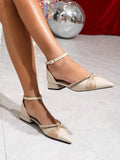 Ivory rhinestone ankle-strap flats worn on a reflective studio floor
