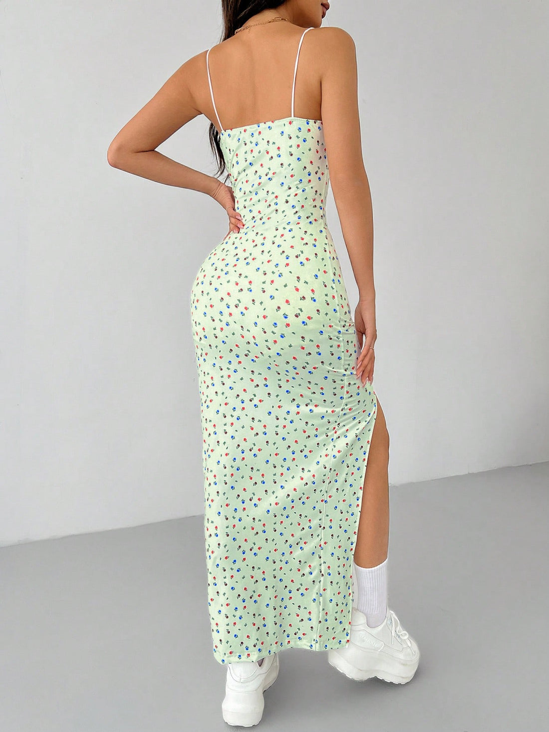 Effortlessly stylish and perfect for summer, our Women's White Ditsy Floral High Split Long Cami Dress is a must-have! Featuring a playful ditsy floral print and a high split for added flair, this dress will keep you cool and chic all season long.