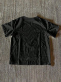 Back view of black short sleeve crew-neck T-shirt with plain finish