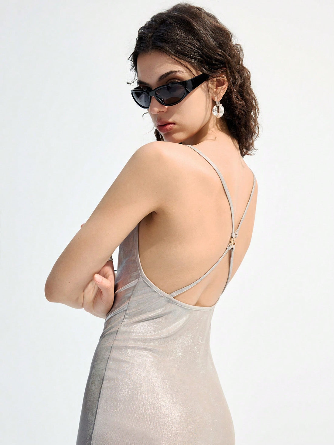 Turn heads this summer in our Elegant Silver Backless Bodycon Dress. Featuring delicate spaghetti straps and a daring side slit, it’s perfect for dancing the night away at any party. The sleek, backless design adds a flirty touch while the bodycon fit highlights your silhouette with effortless charm. Get ready to shine and make every moment unforgettable!