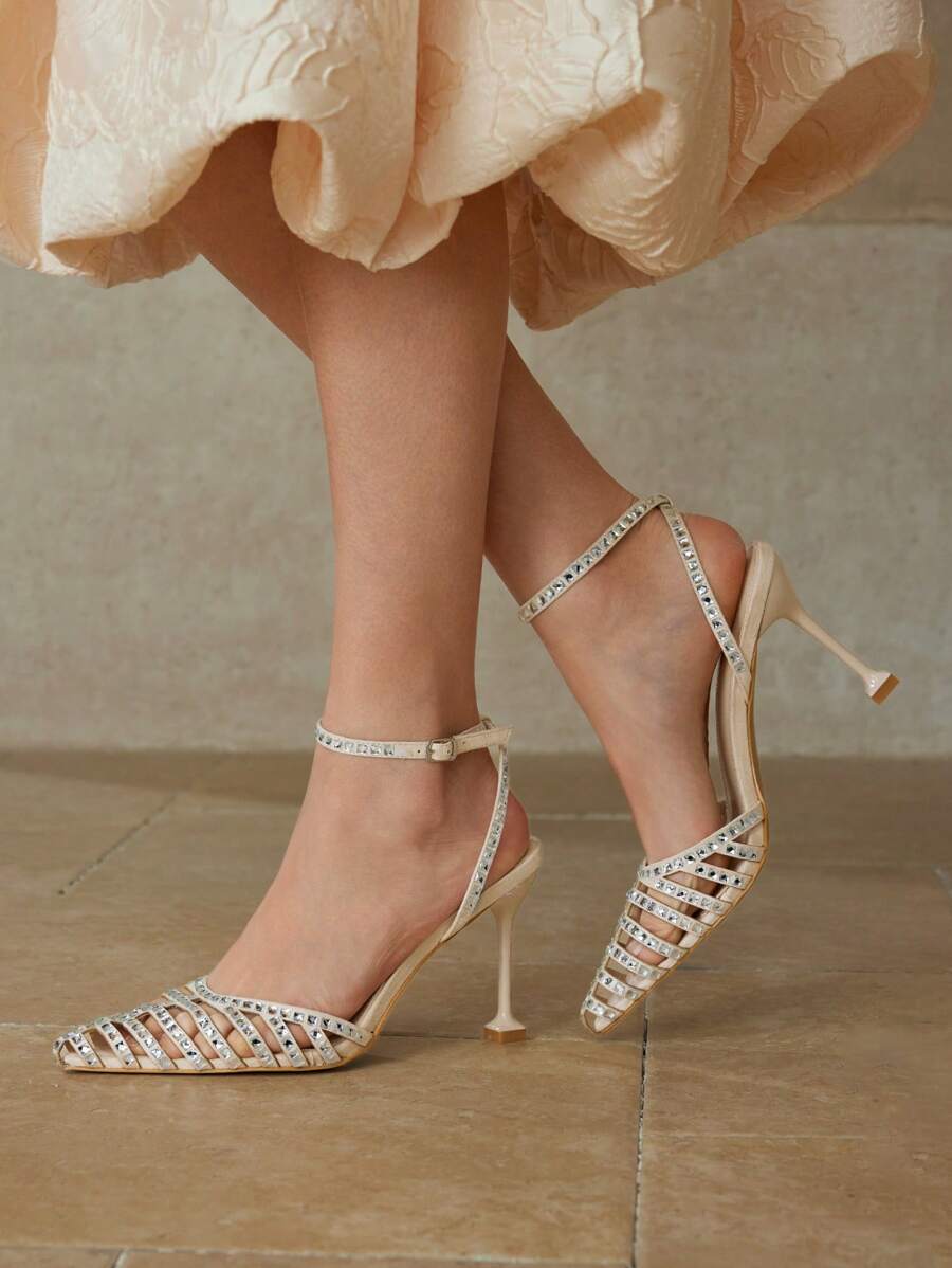 Step out in style with these elegant high heels featuring a sparkling rhinestone embellishment and a chic hollow pointed toe design. Perfect for adding a touch of glamour to any outfit, these heels combine sophistication with a playful edge to keep you shining all night long.