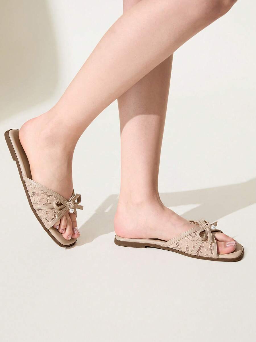Elevate your summer wardrobe with these sophisticated flat sandals, featuring delicate dot mesh detailing and an elegant bow knot accent adorned with pearl embellishments. The square toe design and comfortable flat heel make them perfect for both office settings and special occasions. Crafted with a breathable lace upper, durable TPR outsole, and cushioned PU leather insole, these slides offer all-day comfort without compromising on style. The apricot hue adds a warm, versatile touch to any ensemble, making