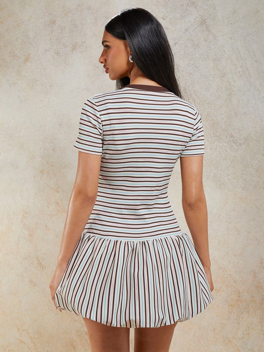 Turn heads in this charming striped mini dress that effortlessly blends retro vibes with modern flair. The playful ruffle hem adds a flirty touch, while the drop waist creates a flattering silhouette that's perfect for any occasion. Short sleeves and a classic round neckline keep things comfortable and versatile, making it ideal for casual outings, weekend brunches, or spontaneous adventures. Whether you're dressing it up with heels or keeping it cool with sneakers, this striped beauty is your go-to piece f