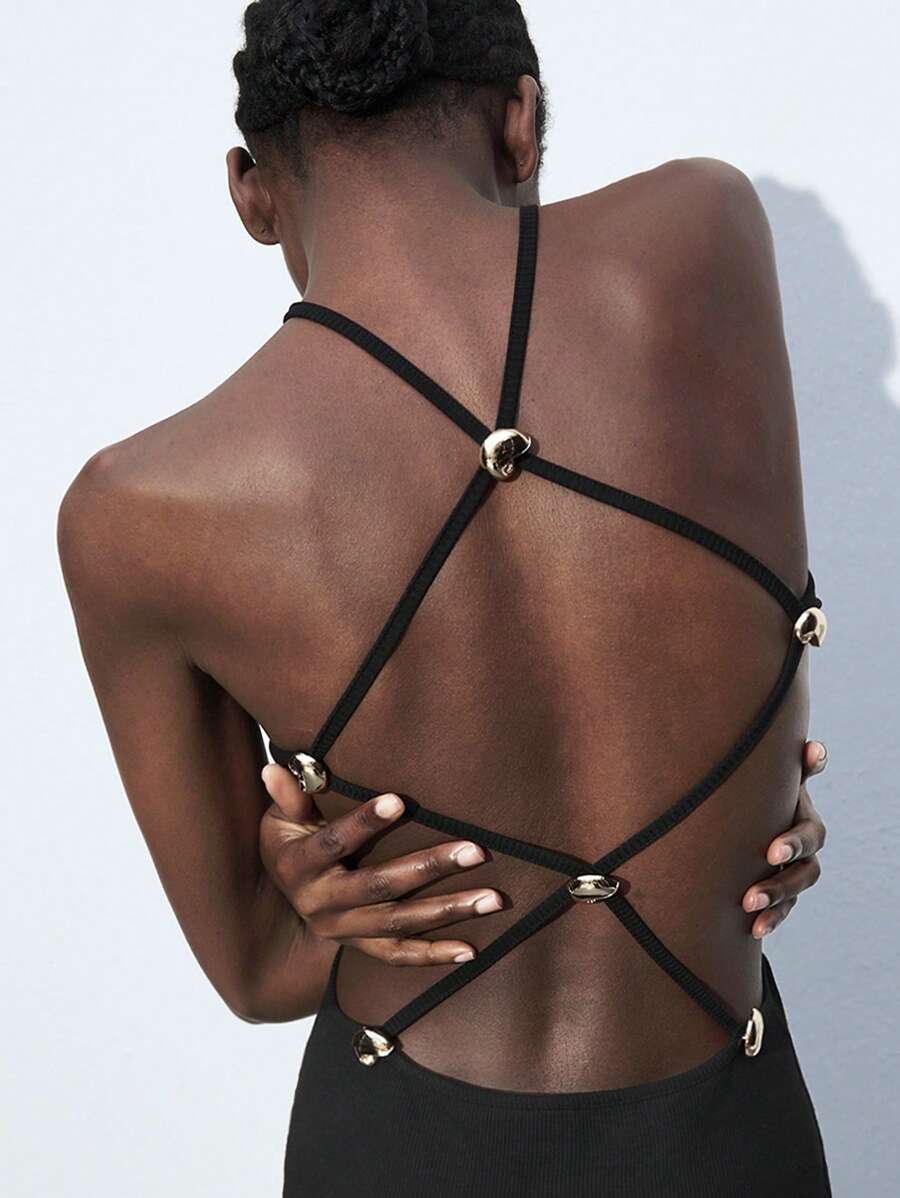 Turn heads in this stunning retro-inspired dress that blends vintage charm with modern flair. The daring backless design features delicate crisscross straps that crisscross elegantly down your back, while a whimsical sea shell buckle adds a touch of coastal glamour. Whether you're dancing at a party, celebrating at a wedding, or enjoying a casual night out, this versatile piece transitions effortlessly from occasion to occasion. The flattering silhouette and playful details make it a showstopper that'll hav