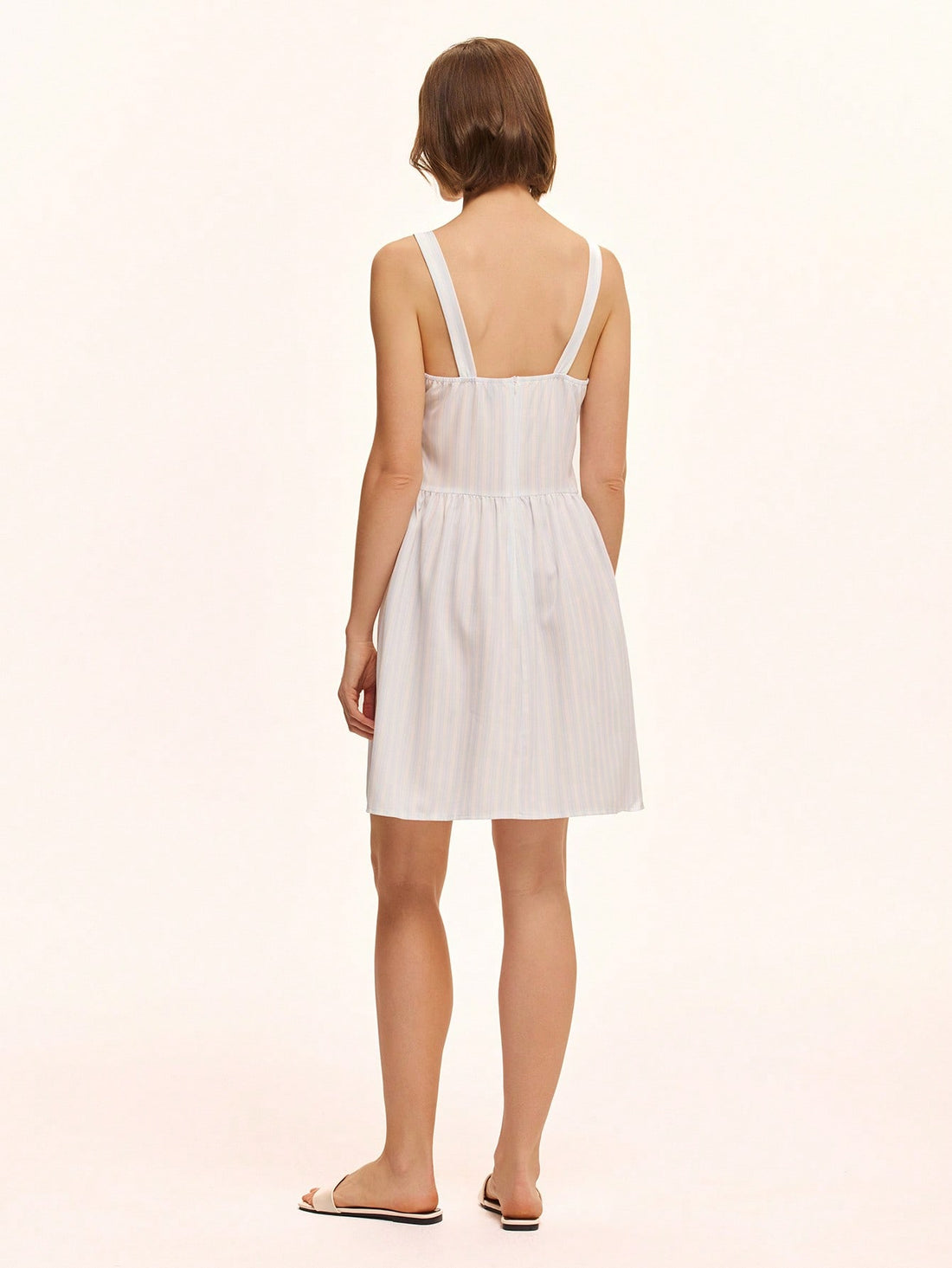 This playful green sleeveless summer dress is perfect for casual days under the sun. Featuring a solid color and a charming front button closure, it offers easy wear and a breezy feel. Its simple yet stylish design makes it a go-to choice for warm weather fun and effortless style.