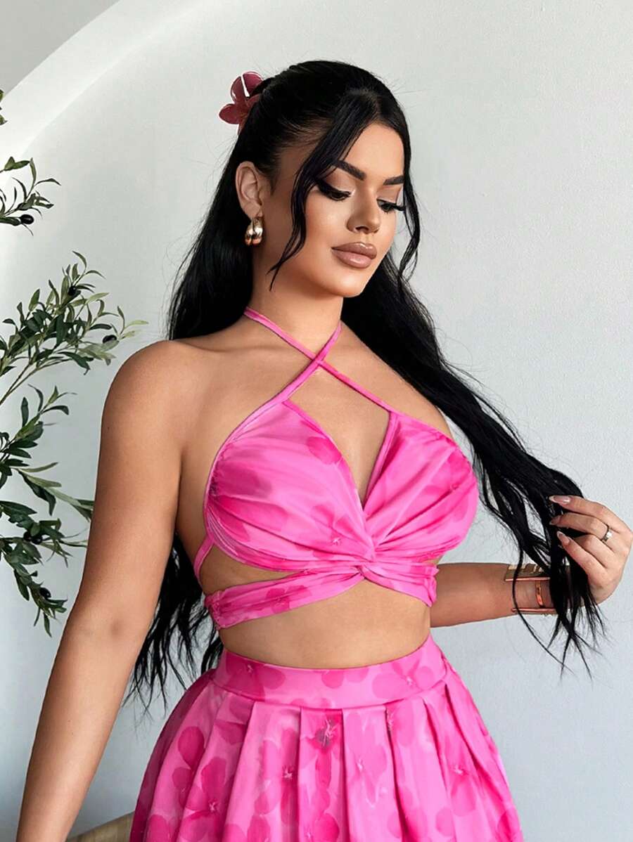 Hot pink floral halter wrap crop top and pleated mini skirt set shown front and back