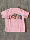Front view of baby pink women’s Jesus graphic T-shirt with ornate faith print