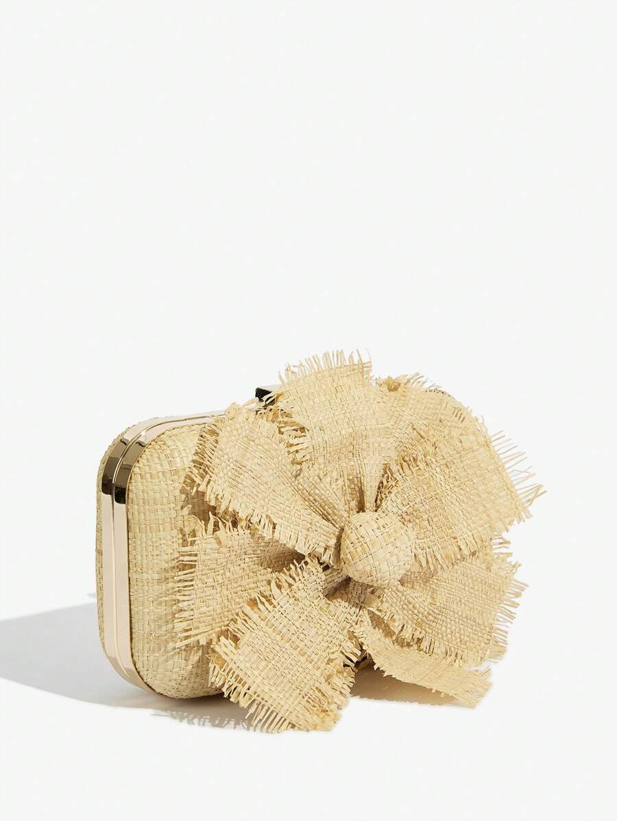 Close-up of raffia flower detail on elegant women's clutch