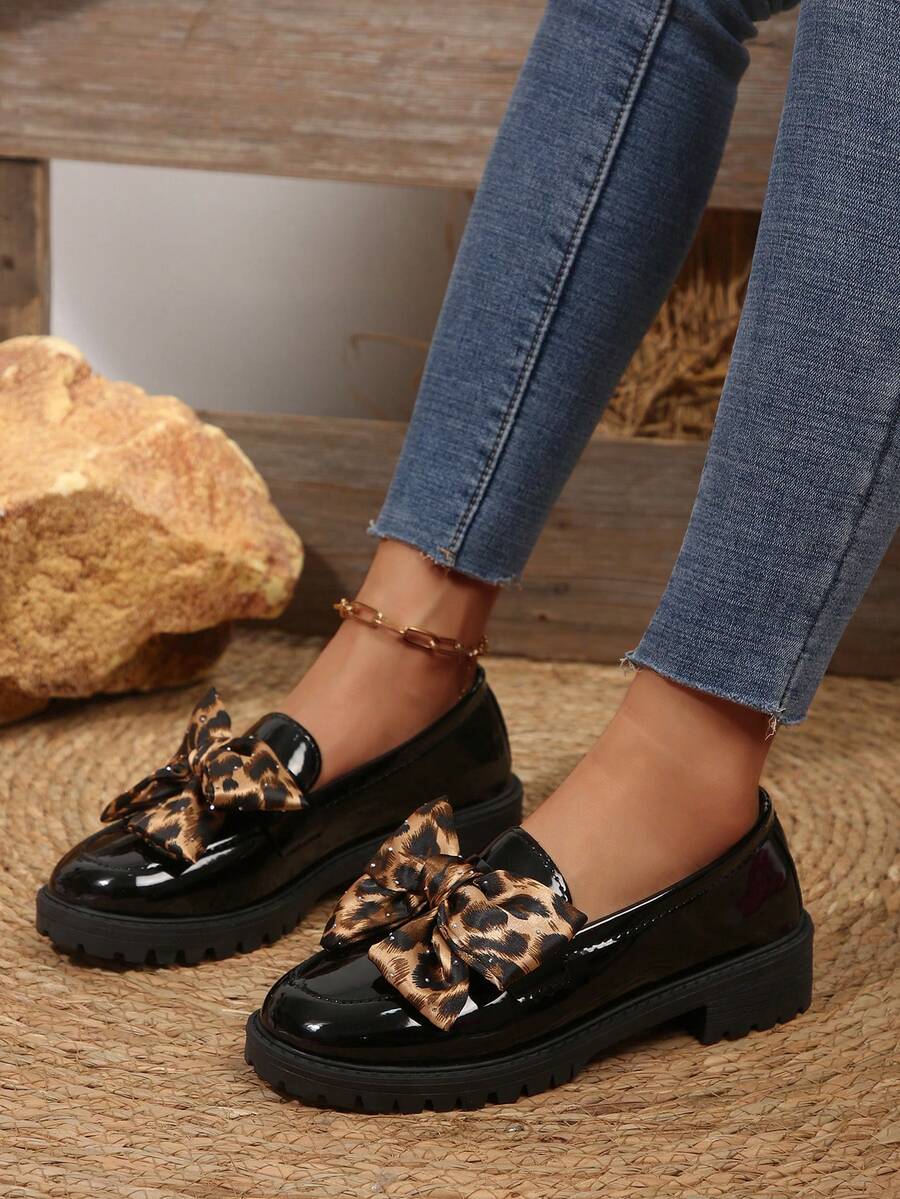 Step into effortless elegance with these British-inspired bow loafers. Featuring a charming bow accent and sturdy flatform sole, they deliver all-day comfort for casual outings and travel. The slip-on design makes them perfect for quick errands, while the durable PU leather upper and PC outsole ensure lasting wear. Note: Fits half-size smaller. Available in classic black, these versatile loafers transition seamlessly from weekend adventures to everyday wear.