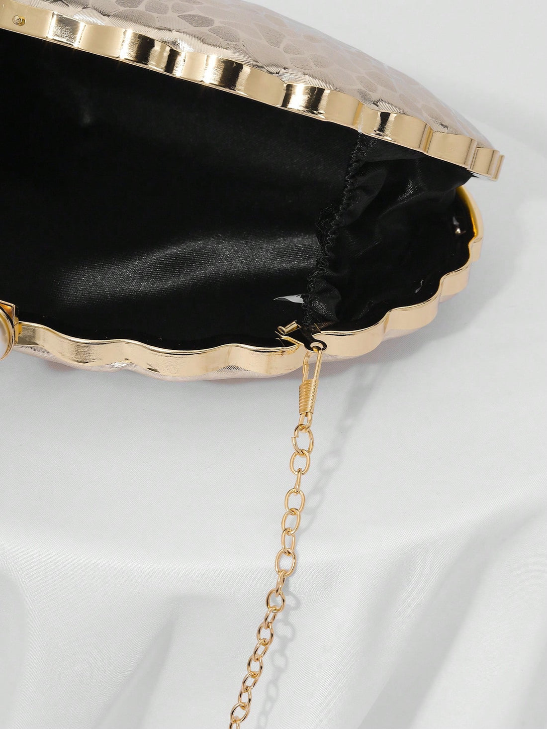 Add a touch of whimsy to your special night with this Elegant Pearl Shaped Clutch. Perfect for weddings and gala events, this stylish evening bag doubles as a charming bridal accessory. Its unique pearl shape brings a playful twist to classic elegance, making it the perfect companion to hold your essentials while turning heads wherever you go.