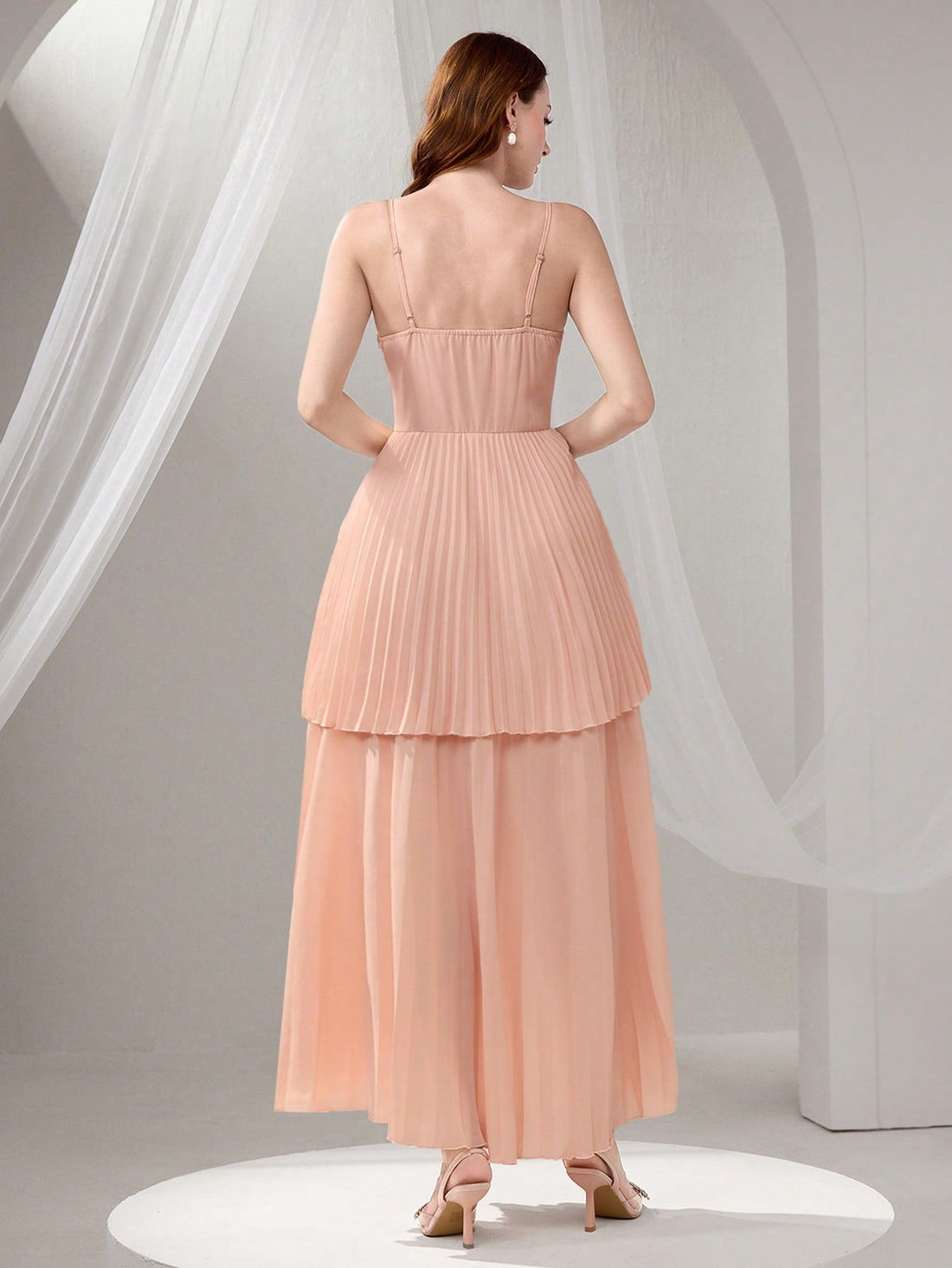 Slip into sophistication with this stunning pleated camisole maxi dress that's ready to steal the spotlight at your next big event. The delicate beaded embellishments catch the light beautifully, while the flowing pleated silhouette creates an effortlessly graceful look. Whether you're celebrating graduation day or dancing the night away at a party, this dress delivers timeless elegance with a modern twist. The camisole neckline offers a touch of allure, and the maxi length ensures you'll feel confident and