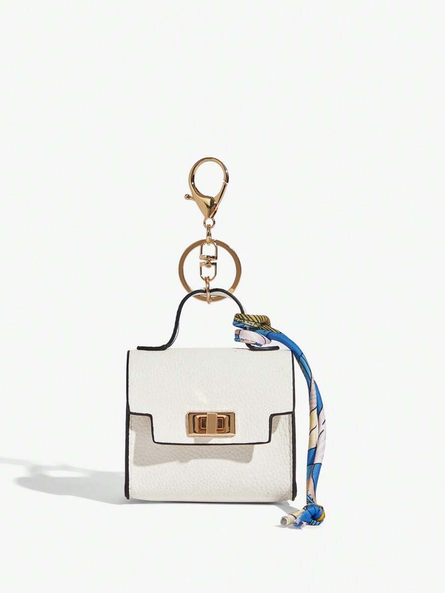Close-up view of mini key ring holder keychain coin purse earphone pouch bag charm with chain strap, coin purse format, key ring detail for small-item storage