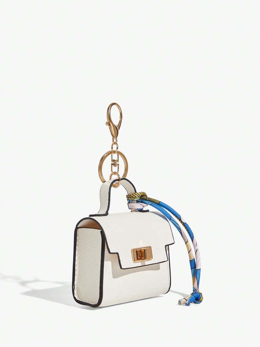 Close-up view of mini key ring holder keychain coin purse earphone pouch bag charm with chain strap, coin purse format, key ring detail for small-item storage
