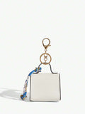 Close-up view of mini key ring holder keychain coin purse earphone pouch bag charm with chain strap, coin purse format, key ring detail for small-item storage