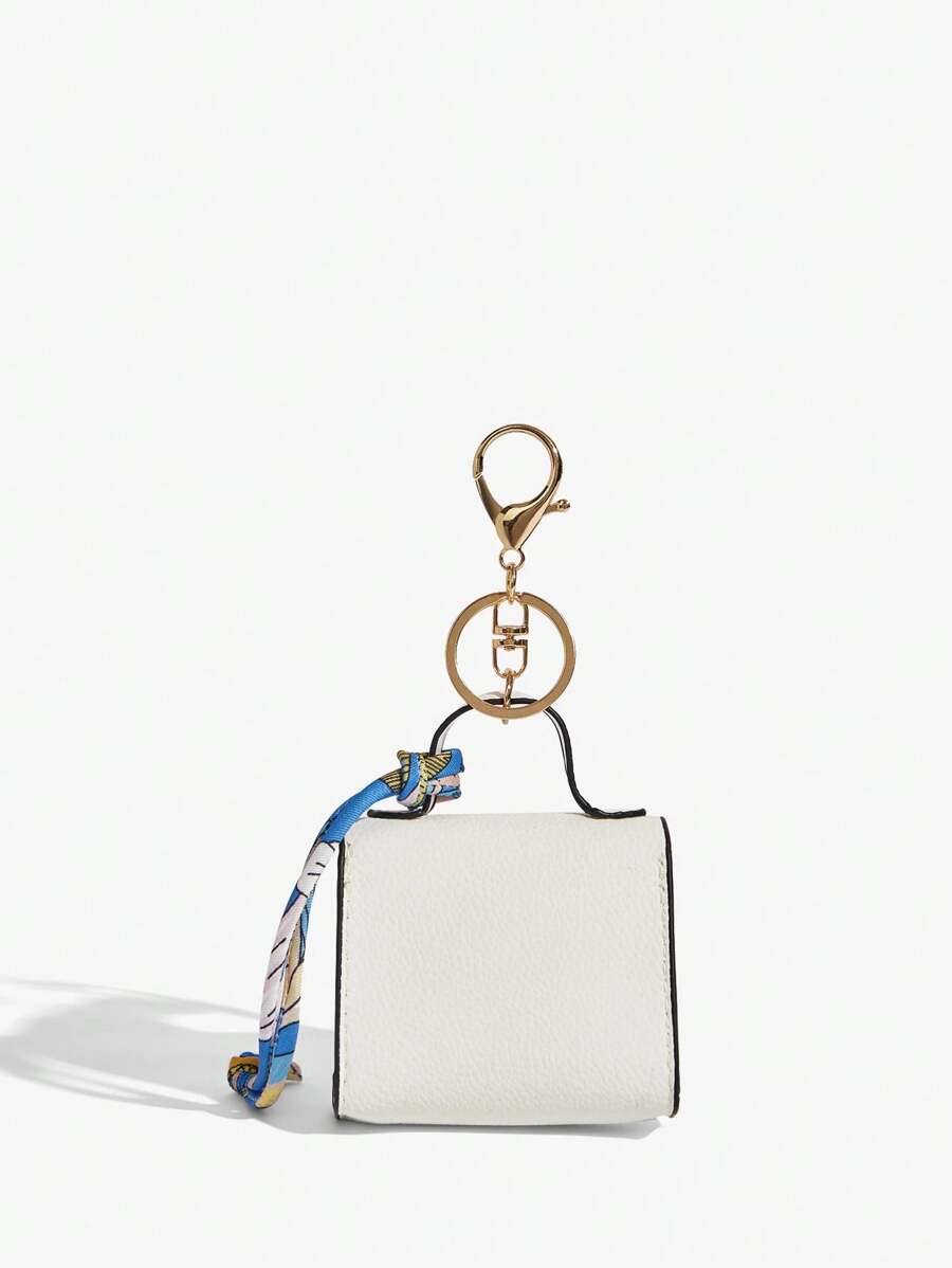 Close-up view of mini key ring holder keychain coin purse earphone pouch bag charm with chain strap, coin purse format, key ring detail for small-item storage