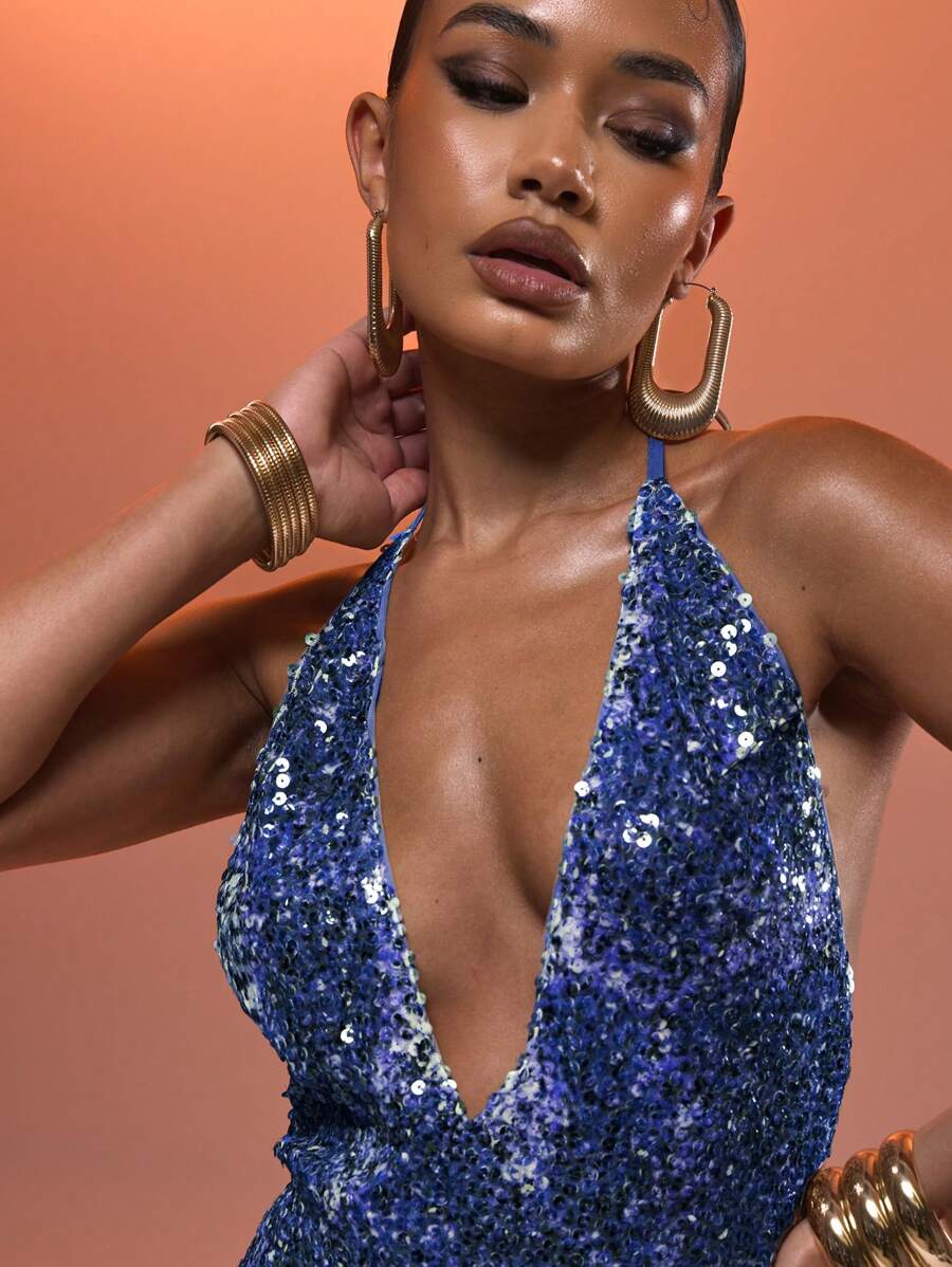 Turn heads this spring and summer in this playful halter neck mini dress sparkling with sequins. The delicate butterfly detail adds a whimsical touch, making it ideal for lively nights out or festive gatherings. Lightweight and eye-catching, it blends glamour with a fun, flirty vibe perfectly suited for warm evenings.