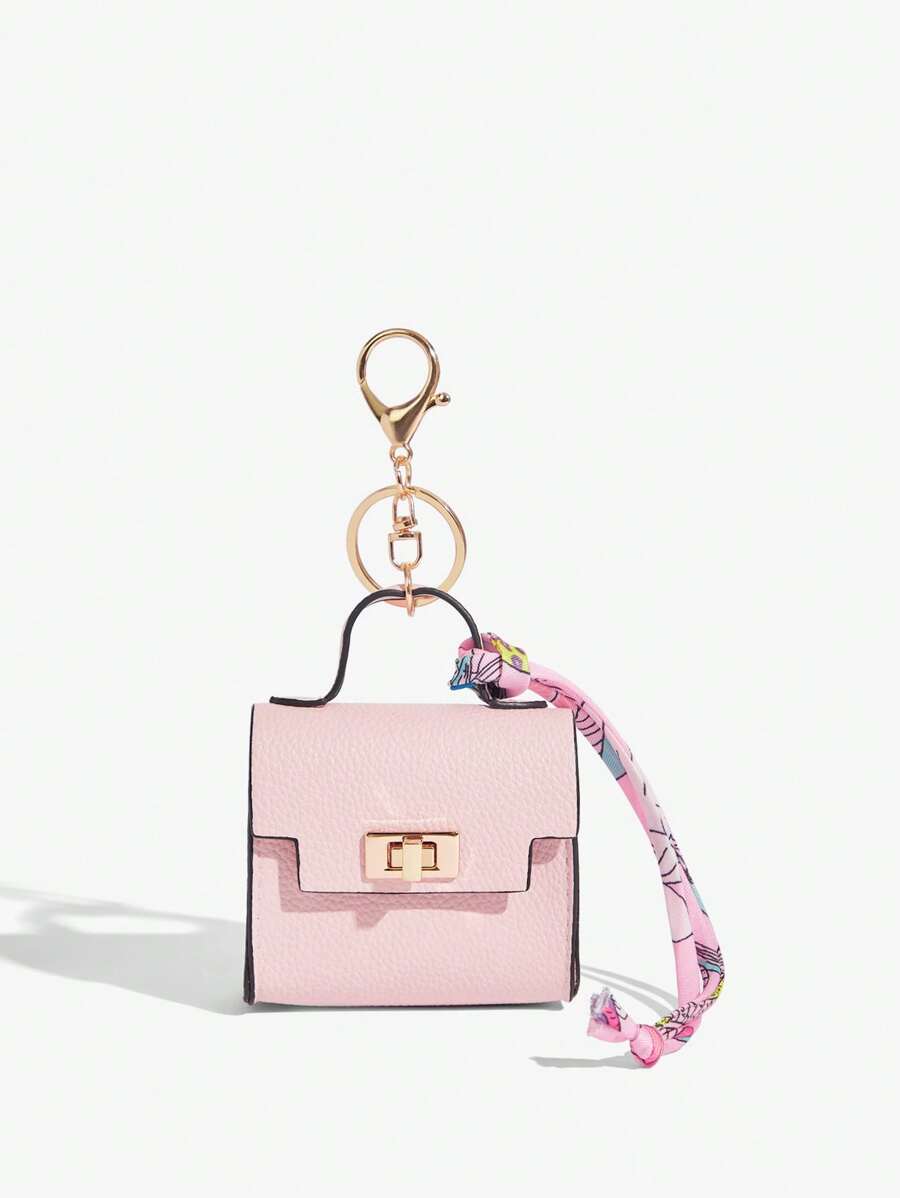 Close-up view of mini key ring holder keychain coin purse earphone pouch bag charm with chain strap, coin purse format, key ring detail for small-item storage