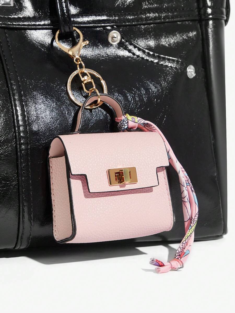 Close-up view of mini key ring holder keychain coin purse earphone pouch bag charm with chain strap, coin purse format, key ring detail for small-item storage