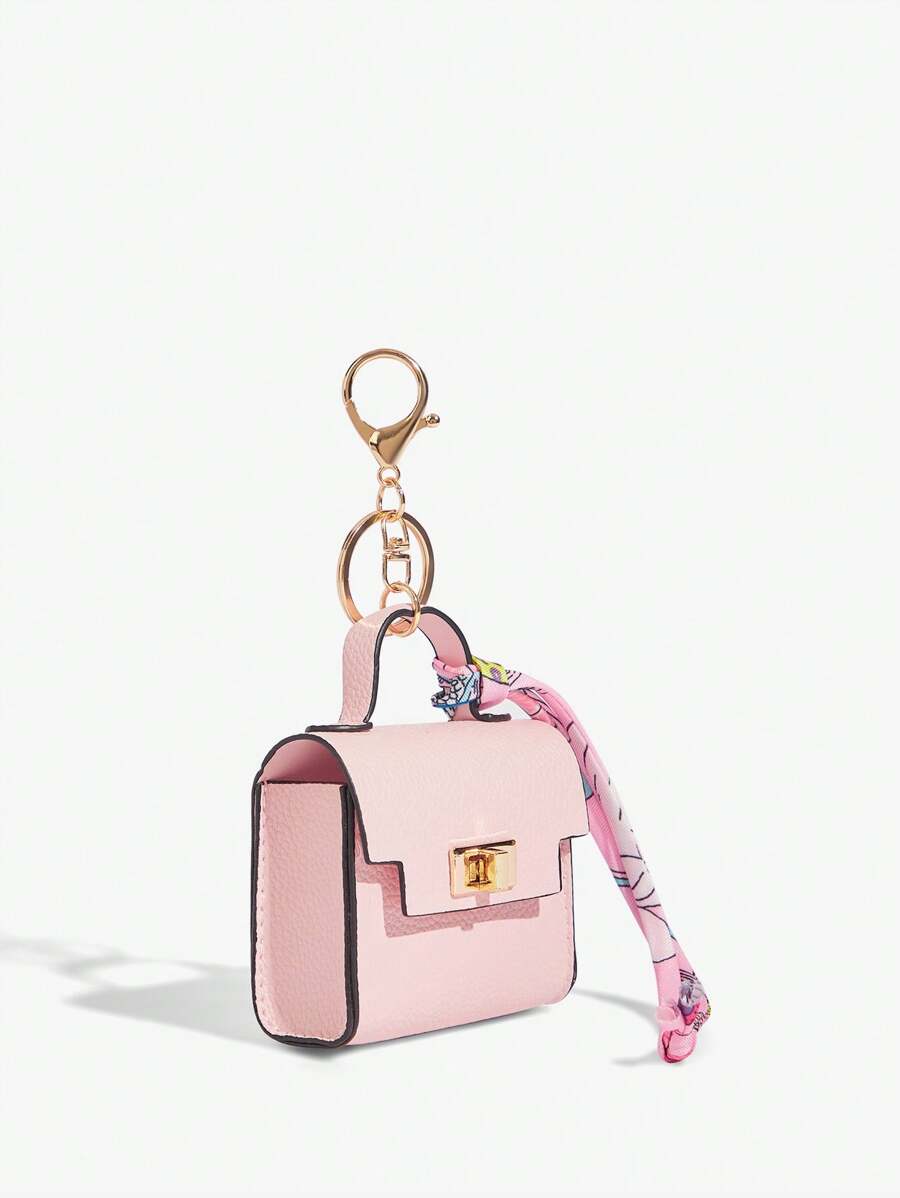 Close-up view of mini key ring holder keychain coin purse earphone pouch bag charm with chain strap, coin purse format, key ring detail for small-item storage