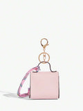 Close-up view of mini key ring holder keychain coin purse earphone pouch bag charm with chain strap, coin purse format, key ring detail for small-item storage