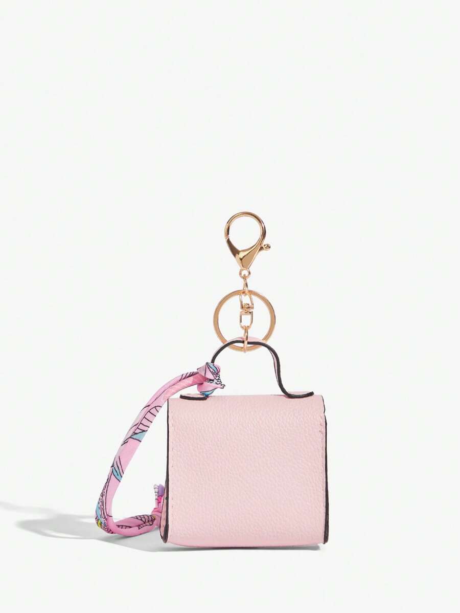 Close-up view of mini key ring holder keychain coin purse earphone pouch bag charm with chain strap, coin purse format, key ring detail for small-item storage