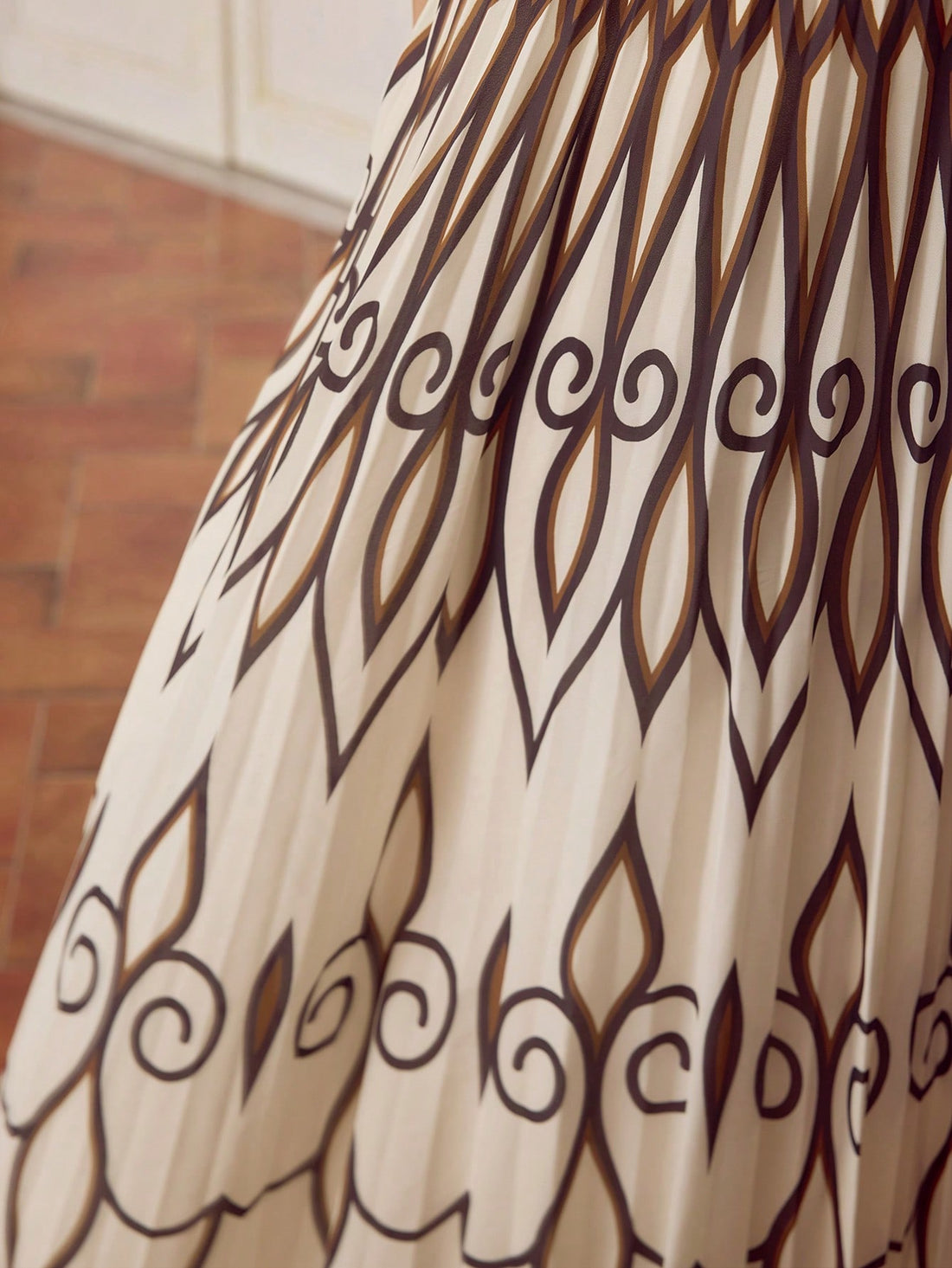 Step out in style with this playful sleeveless maxi dress featuring a bold geometric print. The pleated design adds movement and flair, making it perfect for effortless elegance at any event. Lightweight and breezy, it keeps you comfortable while turning heads wherever you go.