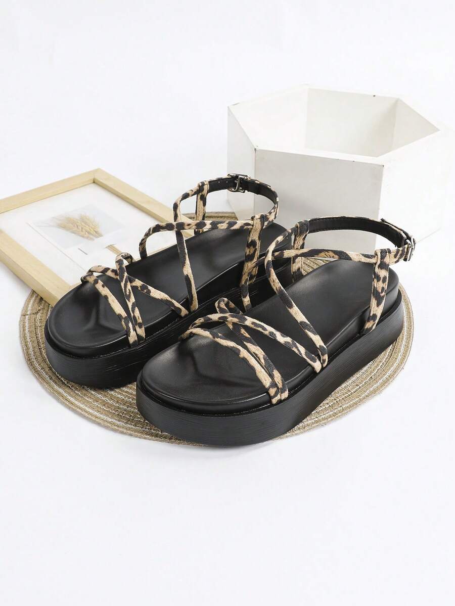 Leopard crisscross platform sandals top view with bold animal print straps and black sole