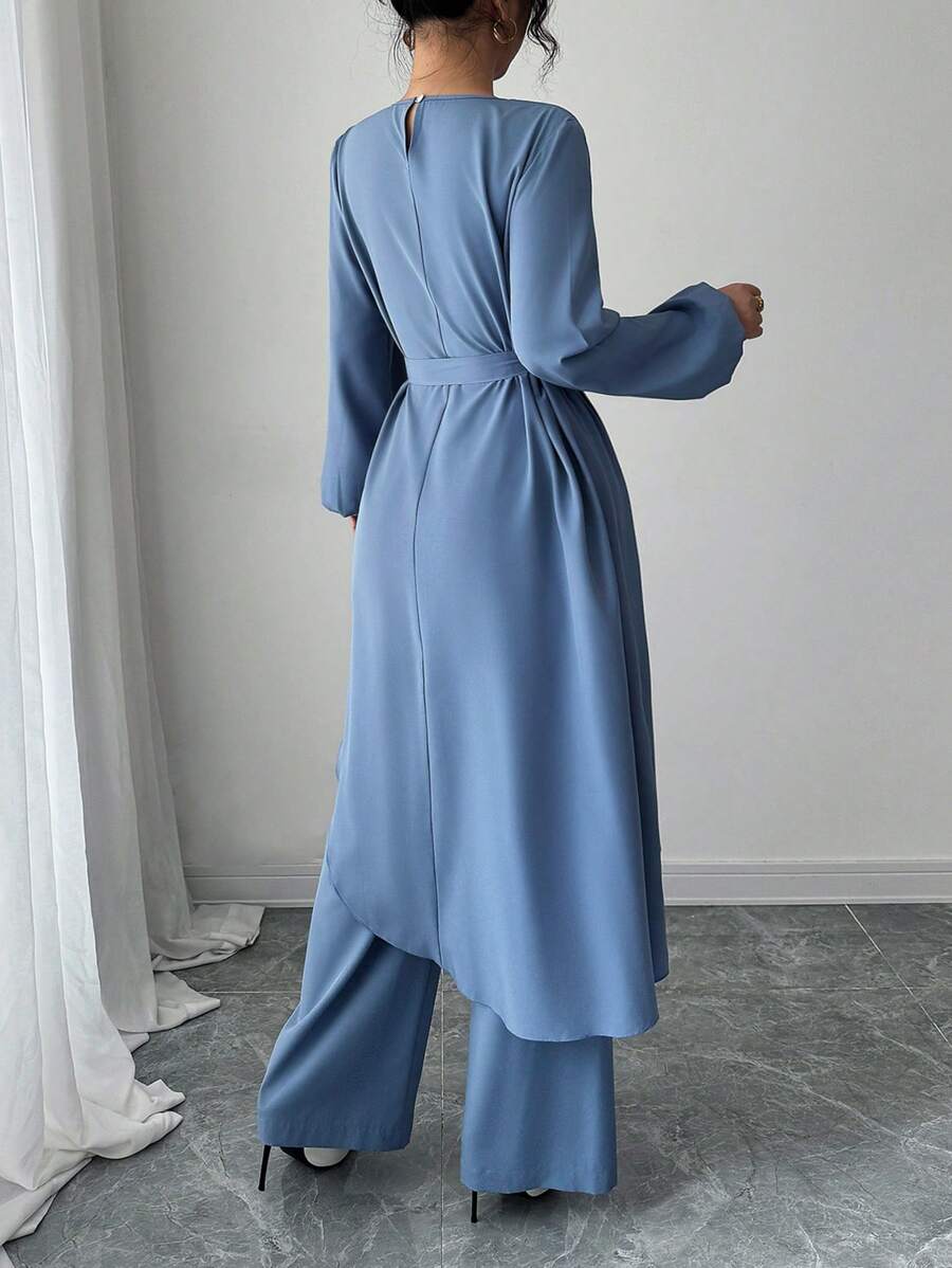 Elevate your fall wardrobe with this chic 2-piece set that's equal parts trendy and effortless. The tie-front top features an eye-catching asymmetrical hem that adds movement and personality to your look, while the coordinating pants keep things polished and put-together. Perfect for transitioning from casual coffee dates to weekend adventures, this solid-color combo works with everything in your closet. Mix, match, or wear them together—either way, you're serving style.