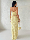 Back view of yellow floral knit two-piece set with low scoop top and maxi skirt