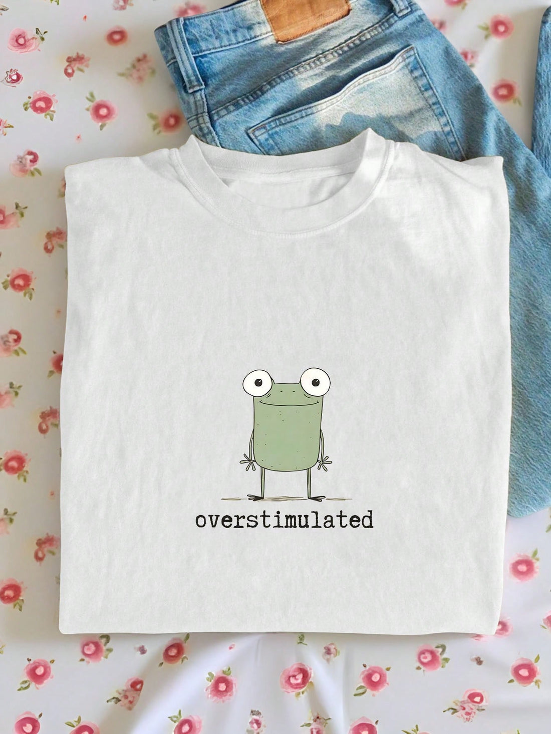 Express your quirky side with our Overstimulated Weird Frog Graphic Tee! This women's t-shirt features a hilariously chaotic frog design that perfectly captures that "too much coffee" energy we all know and love. Made for the bold fashionista who isn't afraid to stand out, this conversation-starting tee pairs perfectly with jeans, skirts, or under a casual blazer. Hop into your new favorite wardrobe staple!