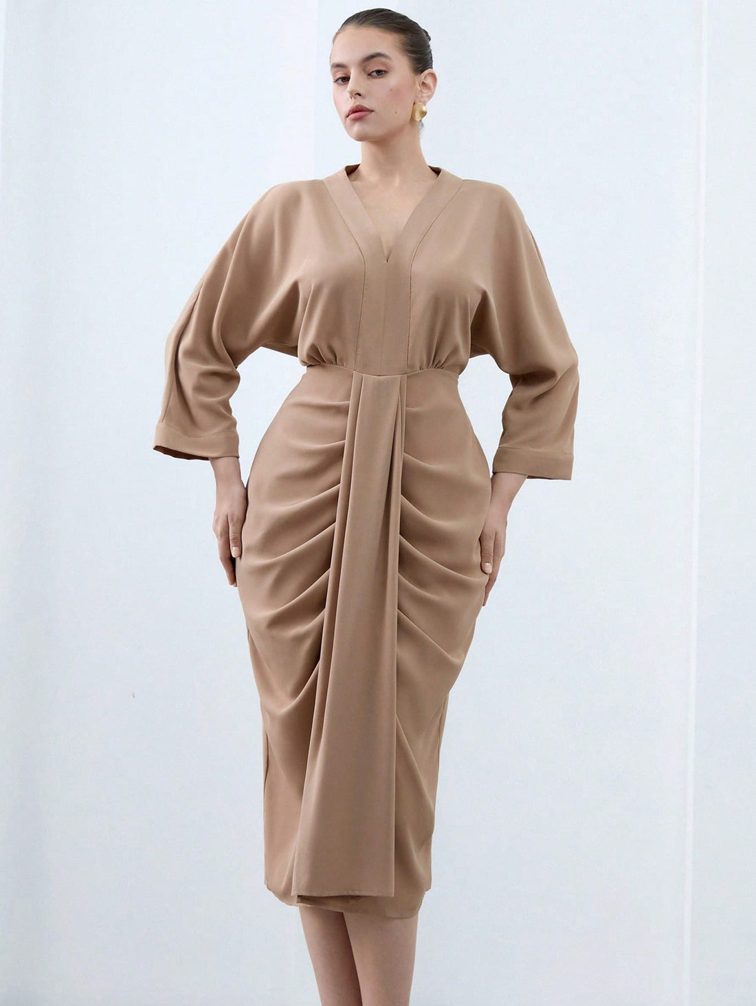 Turn heads effortlessly in this Elegant Plus Size V-Neck Midi Bodycon Dress. Featuring a flattering V-neckline, playful ruffle hem, and chic 3/4 sleeves, it hugs your curves in all the right places. Perfect for any occasion where you want to feel confident and fabulous with a touch of fun!