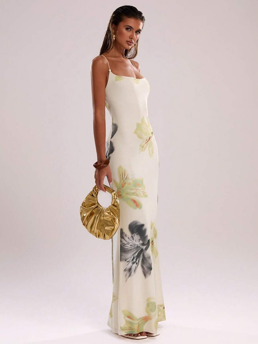 Elevate your warm-weather wardrobe with this stunning ombre gradient cami dress. Featuring a flattering backless design with criss-cross lace-up detailing and delicate spaghetti straps, this maxi dress combines elegance with effortless style. The all-over botanical print and slim-fit silhouette create a graceful mermaid hem that flows beautifully. Crafted from a high-stretch knit blend of polyester and elastane, it offers comfort and flexibility for all-day wear. Perfect for beach getaways, casual outings, 