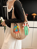 Tan crochet mesh shoulder bag worn on shoulder with colorful embroidered figure patches