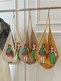 Cream tan and mustard crochet mesh shoulder bags hanging with colorful figure appliques