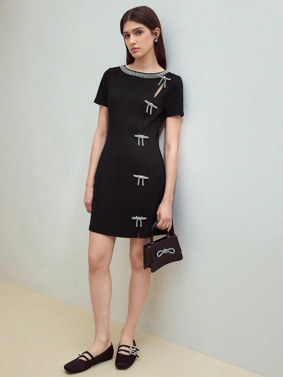 Turn heads on your next date with this playful mini dress featuring a sparkling rhinestone bow accent. Its short sleeves and flattering cut combine comfort with chic style, making it perfect for evenings filled with fun and flirtation. Embrace your confident, stylish side effortlessly!